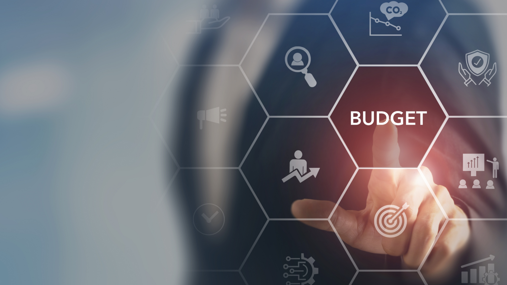 Holographic design depicting the elements of an operating budget with a person&#39;s hand in the background.