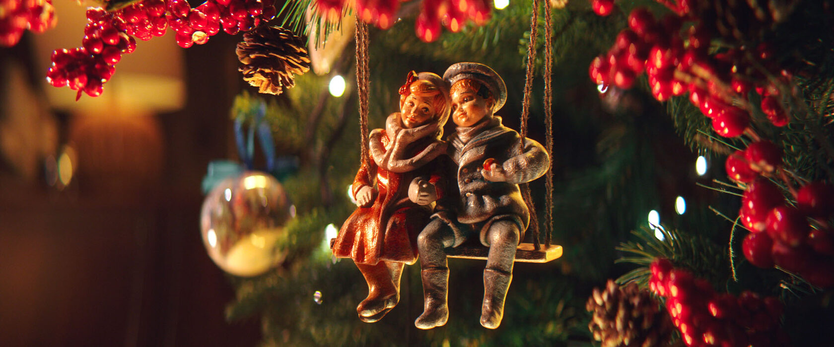 Two astronaut ornaments reunited on a Christmas tree