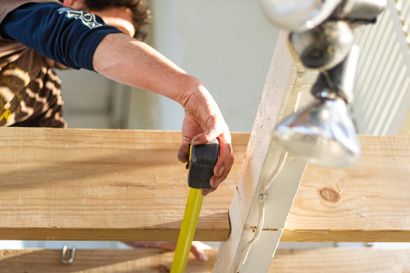Builder meassuring joist