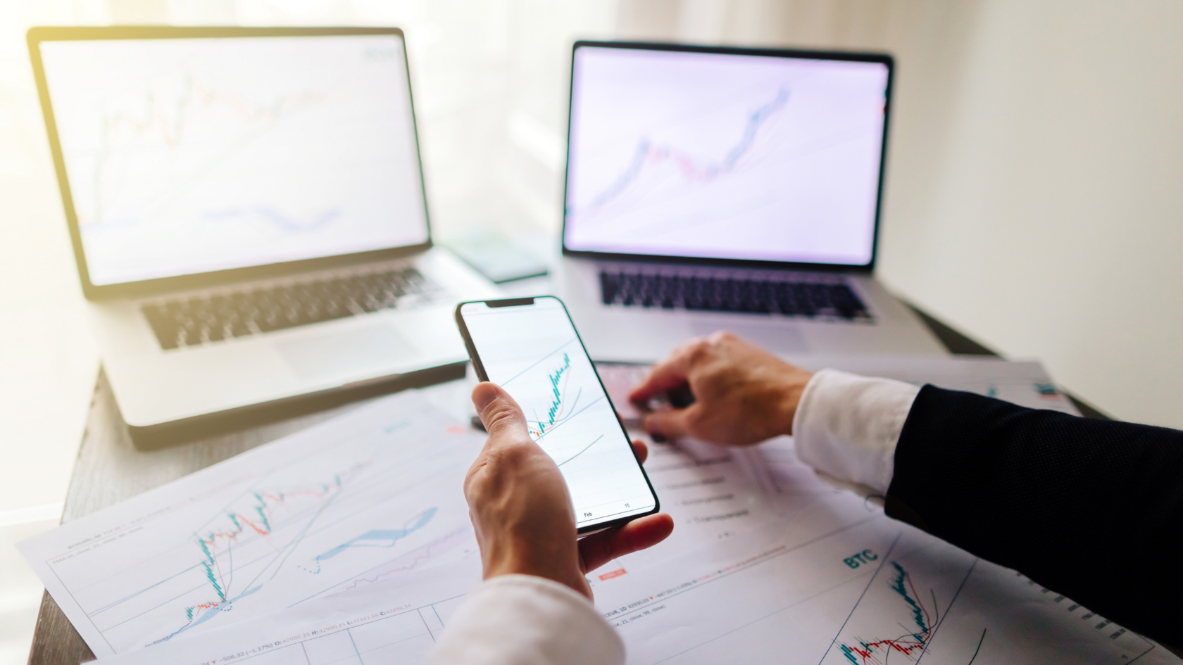Computer screens and documents showing charts indicating growth-stage financing trends.